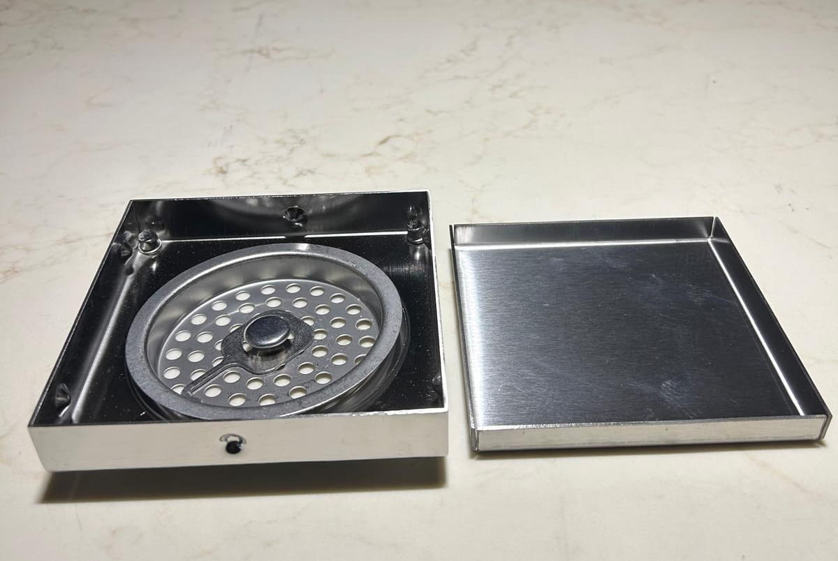 Square stainless steel 304 floor trap grating with a brushed finish.