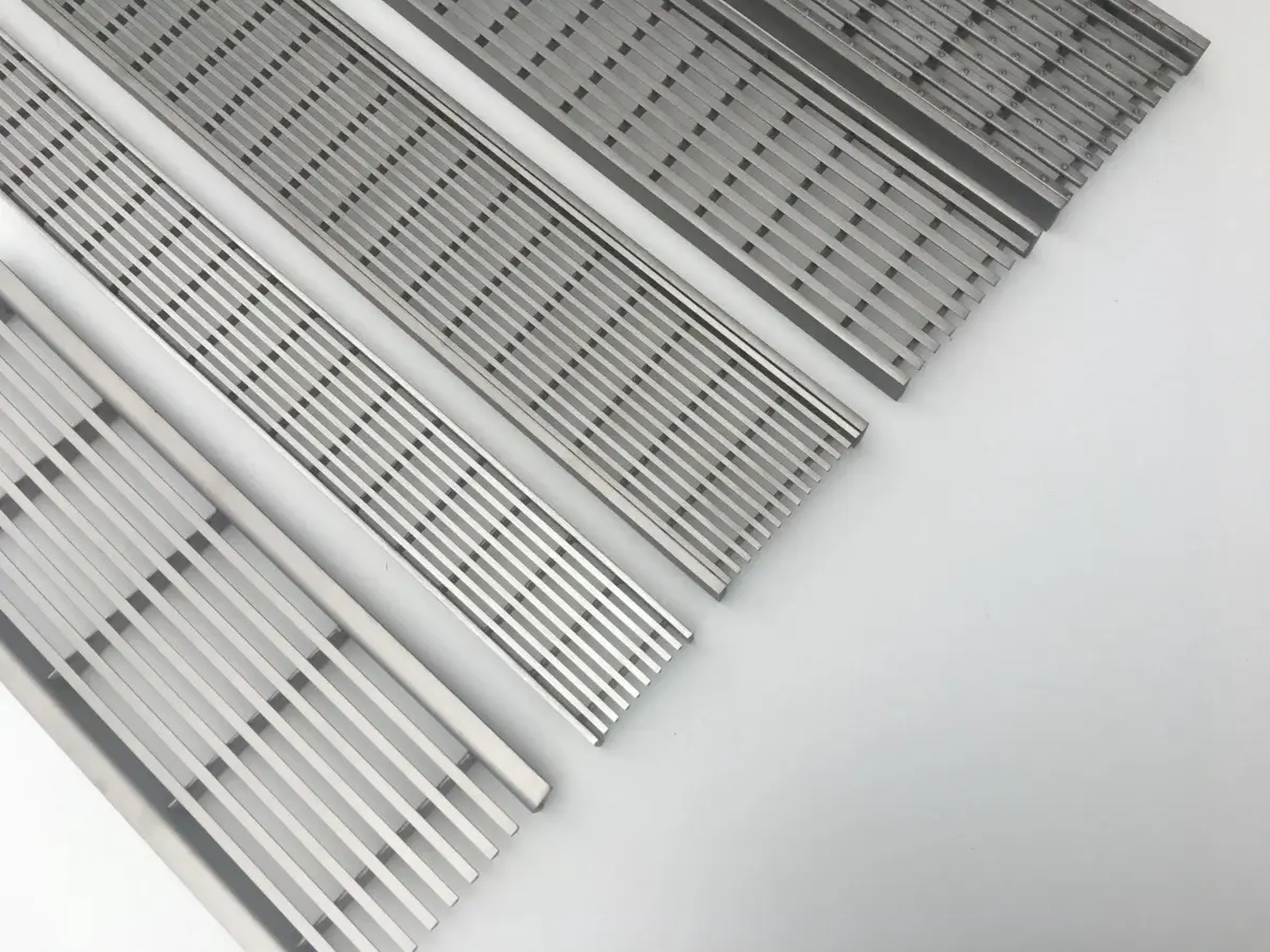 Recessed stainless steel drain grating for a hidden, seamless drainage look in gardens.